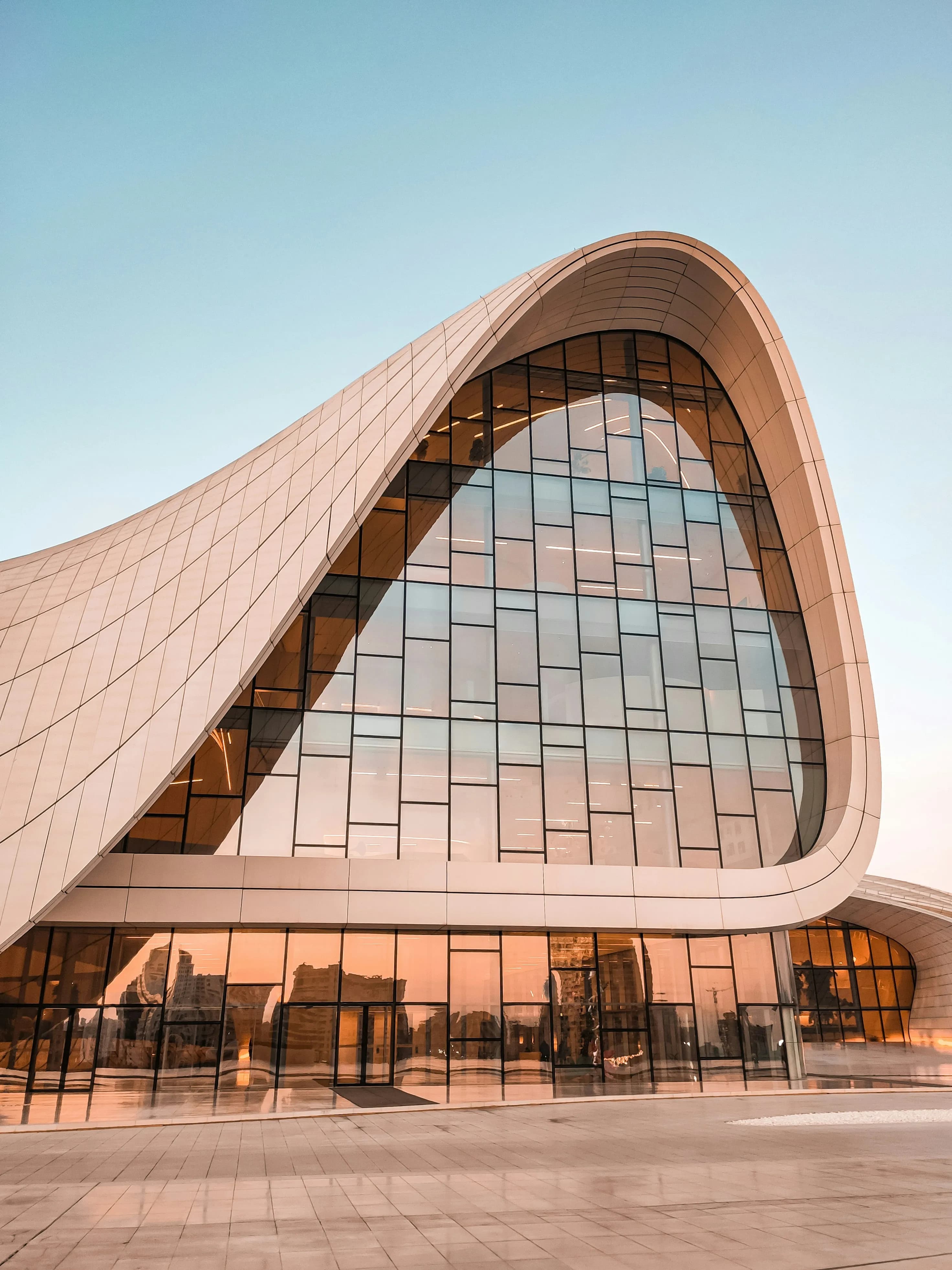 Curved golden cultural architecture with organic timber arches and modern design